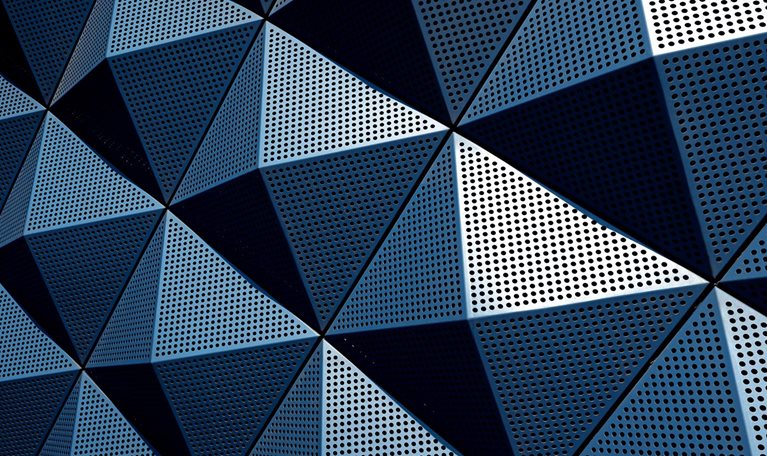 A wall composed of repeating metal triangular pyramids.