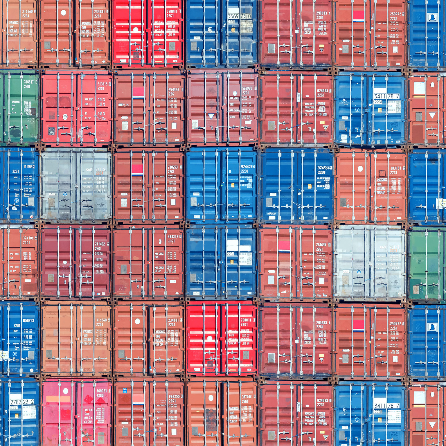 Stacked shipping containers filling the image from edge to edge.