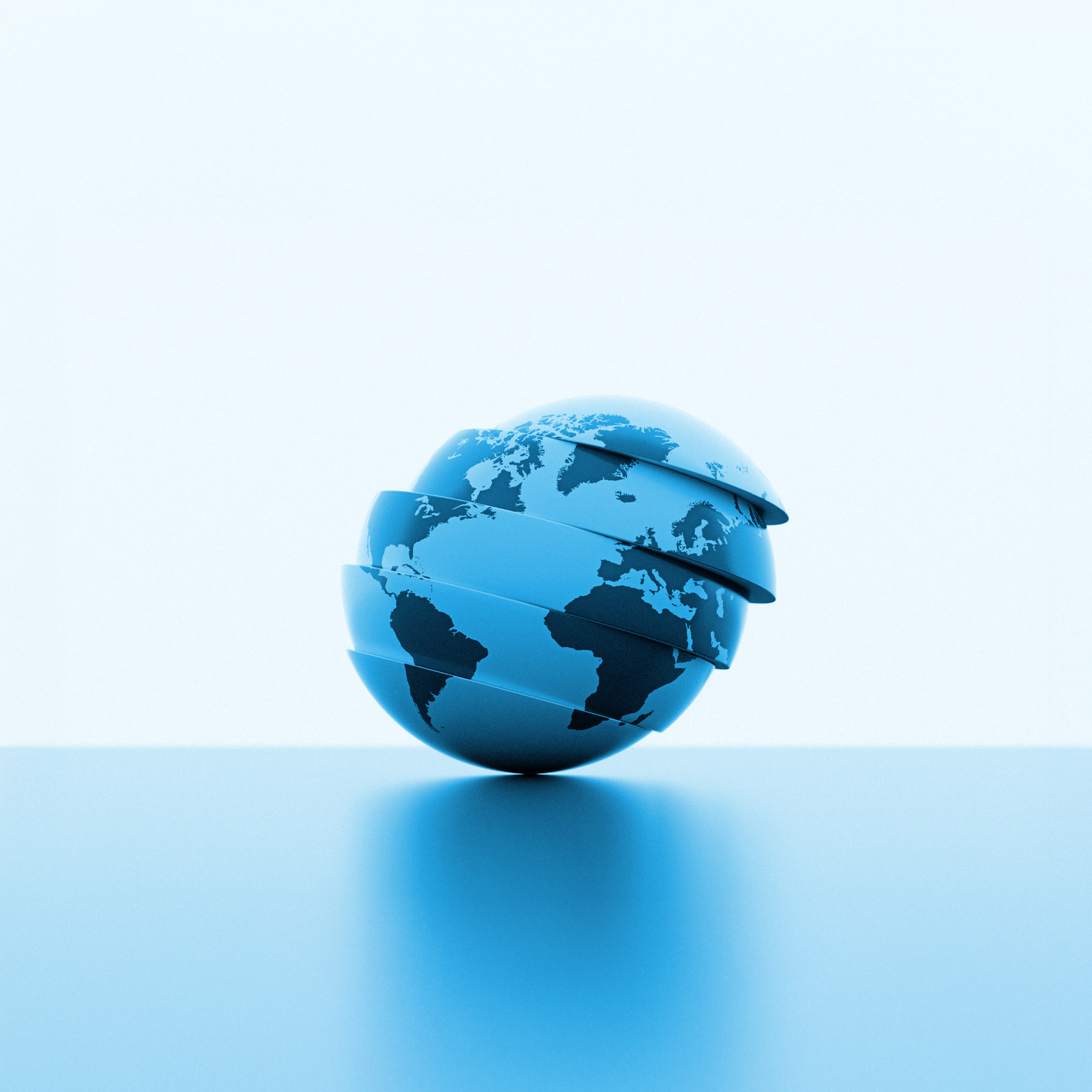 A stylized blue globe with continents visible, divided into several horizontal slices slightly separated from each other. The sphere tilts gently to one side as the layers appear to float above a smooth surface, creating a modern, futuristic look.