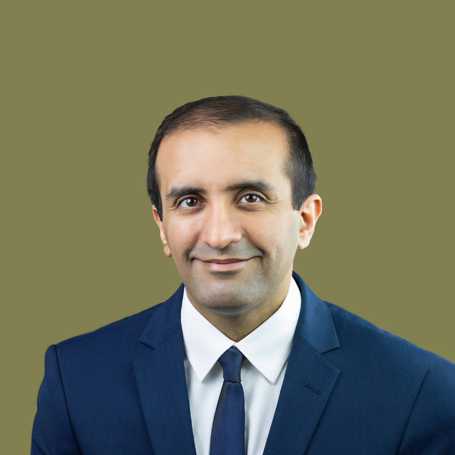 Portrait of Raj Panjabi with an easy smile and a blue suit.