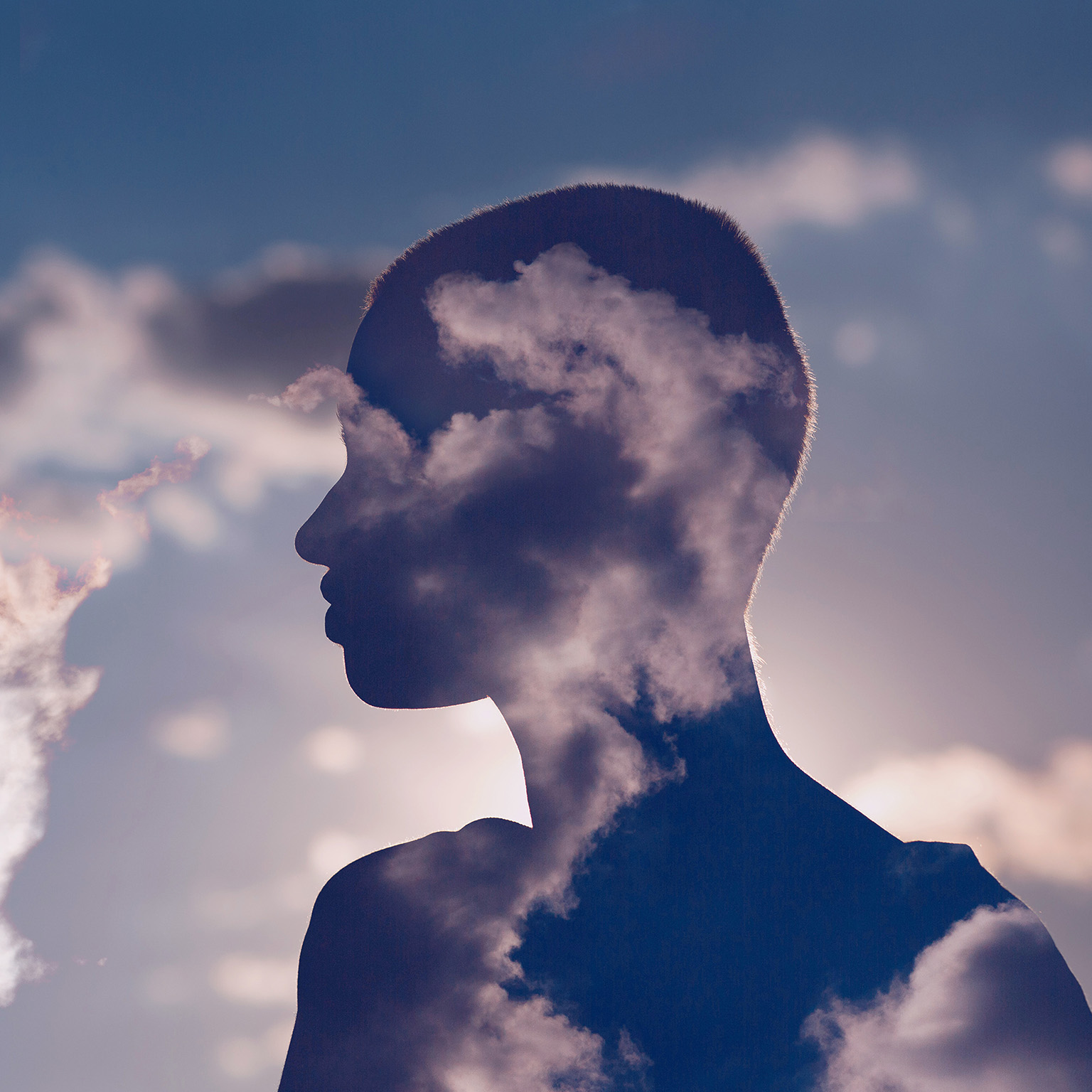 Photo illustration of a woman's silhouette enhanced by clouds