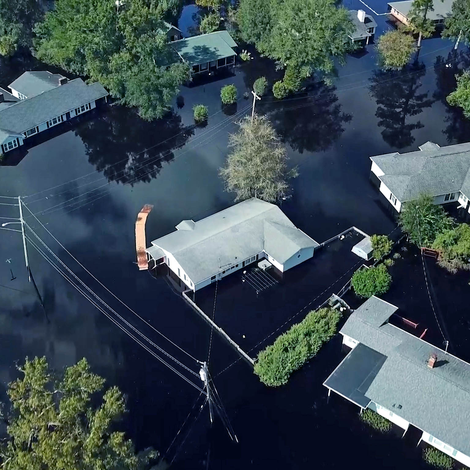 Homes surrounded by flood water in South Carolina after a hurricane.